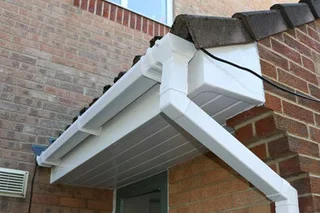 A house with guttering and a downpipe system.